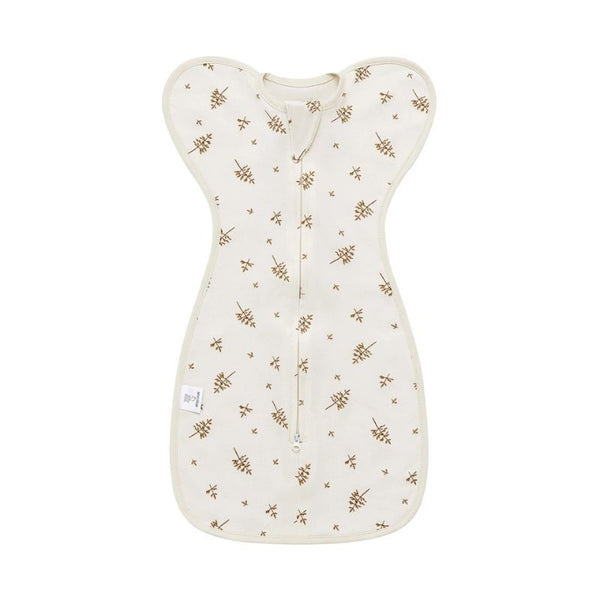 Gigoteuse d'Emmaillotage beige décorée de motifs végétaux, pour un sommeil naturel et sécurisé.