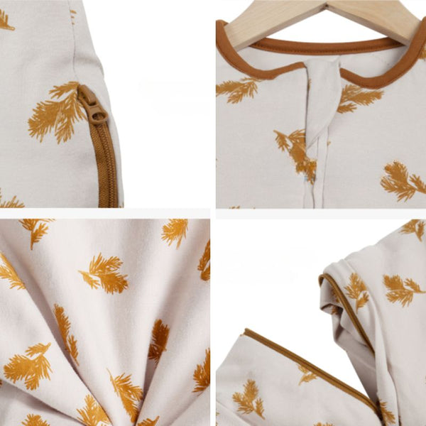 Zoom sur détails couture et tissu de la Gigoteuse Hiver à feuilles dorées