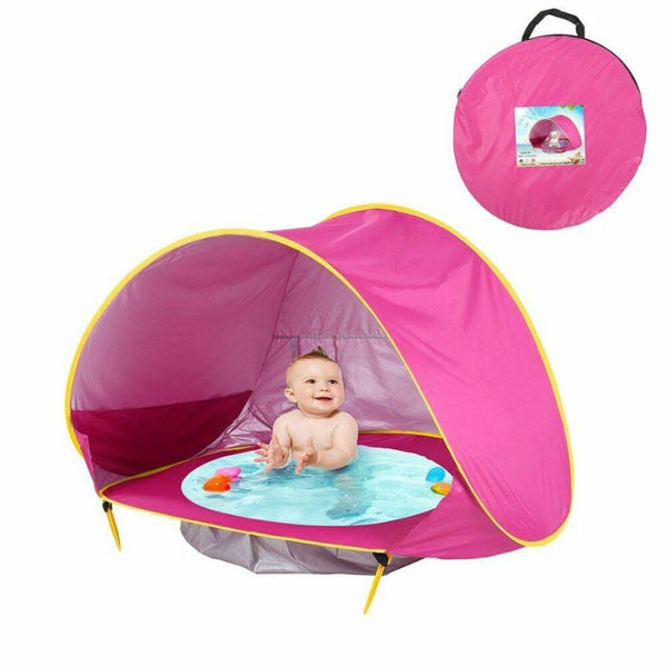 Tente de plage bébé rose fuchsia avec bassin intégré, sac de transport et accessoires inclus pour une installation rapide.