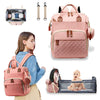 Sac à dos à langer rose avec compartiment lit pratique, conçu pour les déplacements avec bébé.