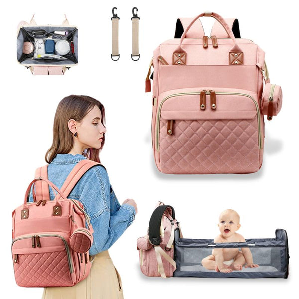 Sac à dos à langer rose avec compartiment lit pratique, conçu pour les déplacements avec bébé.