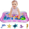Bébé jouant sur le tapis d'eau bébé BabyFish rose avec des créatures marines mignonnes.