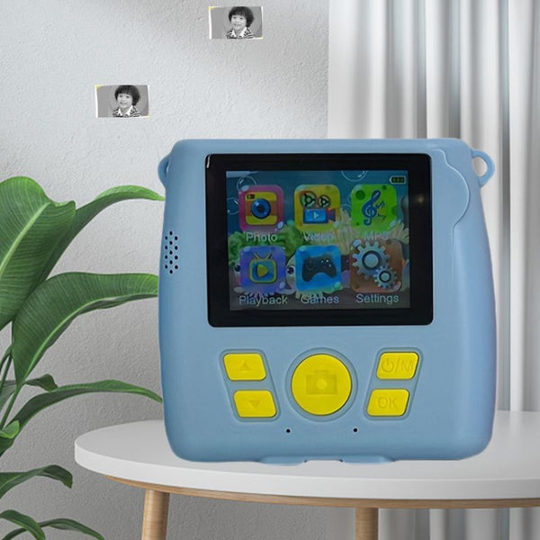 Appareil Photo Enfant bleu posé sur une table, fonction Impression Instantanée