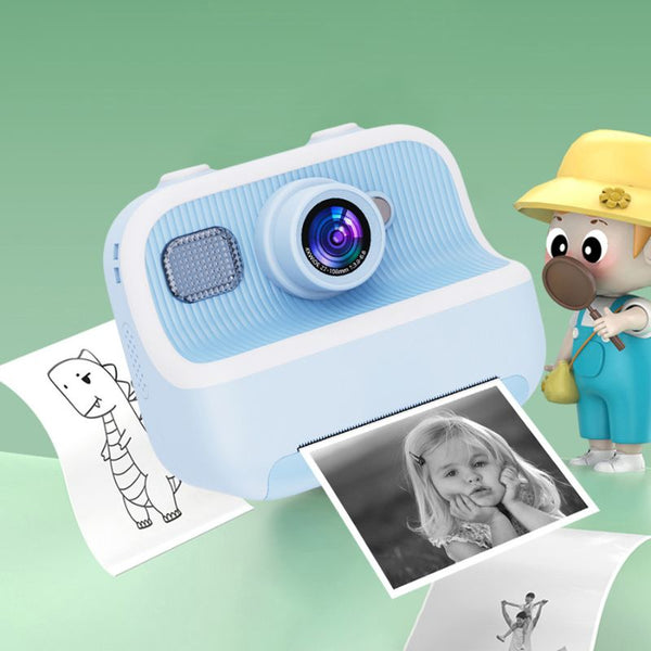 Appareil photo bleu pour enfants avec une photo et un livre de coloriage sur fond vert - Appareil Photo Enfant Impression Instantanée Sans Encre